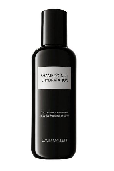 Sort flaske med hvid etiket, "SHAMPOO No. 1 L'HYDRATATION", uden parfume eller farve.